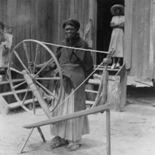 Lucindy Lawrence Jurdon with her mother's spinning wheel_ 1937_ Alabama